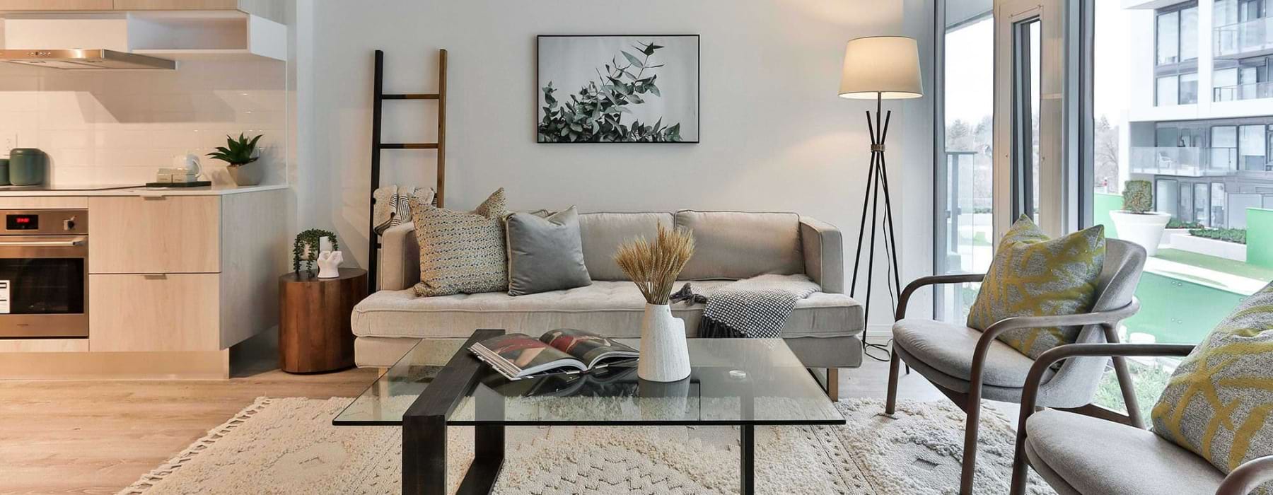A living room with a couch and a coffee table next to a large window.