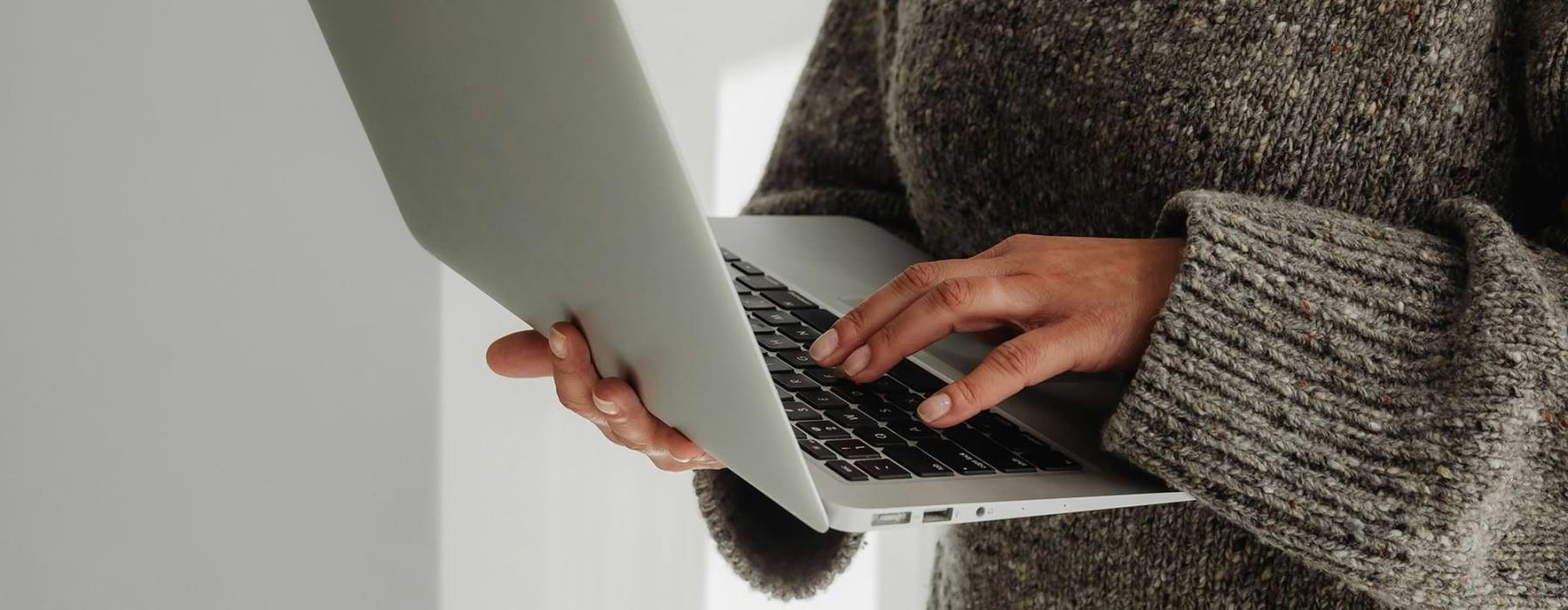 A person holding a laptop.