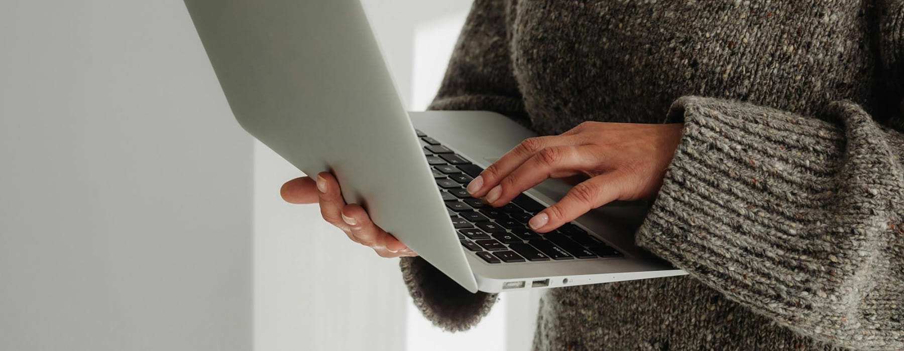 A person holding a laptop.