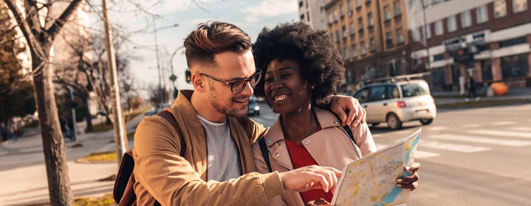 couple on a street looking at map